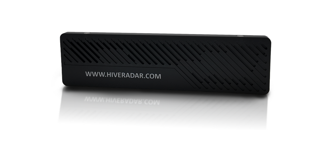 A black rectangular plastic slot cover with diagonal textured ridges and white text 'WWW.HIVERADAR.COM' on its surface. Photographed on a professional studio background.