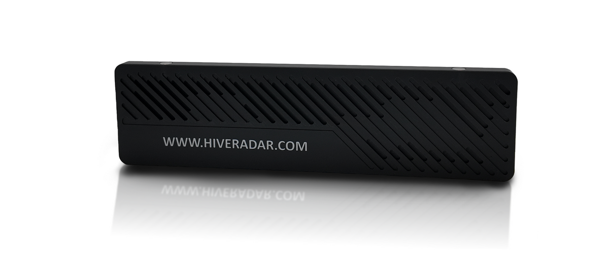 A black rectangular plastic slot cover with diagonal textured ridges and white text 'WWW.HIVERADAR.COM' on its surface. Photographed on a professional studio background.